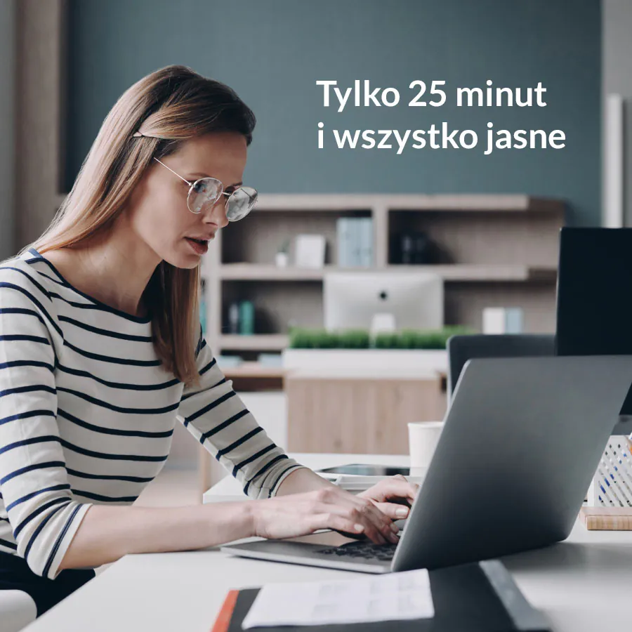 a woman sitting at a desk using a laptop